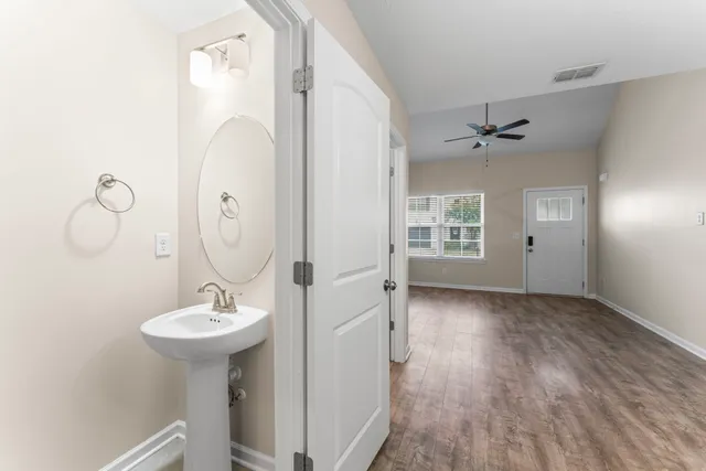 a bathroom with a sink mirror and window