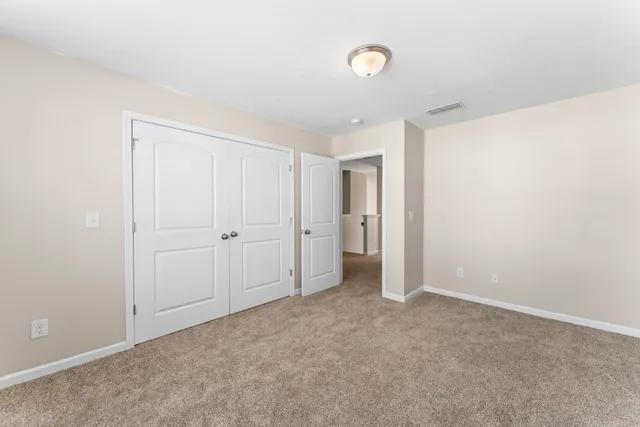 a bathroom with a granite countertop sink a toilet and shower