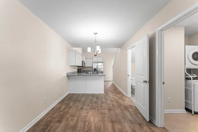 a view of a kitchen with a sink and refrigerator