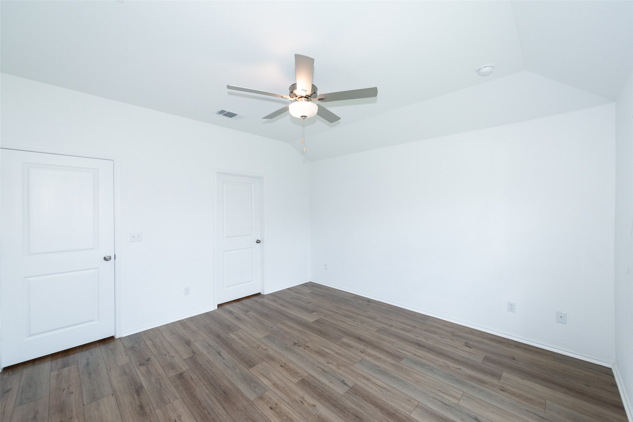 147 Otter Road Kyle, TX 78640 - Photo 23 of 34 primary bedroom entry door on left, primary bath entry on right