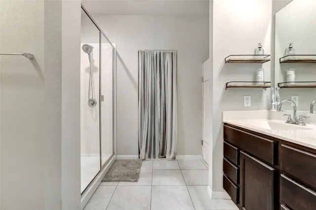 a bathroom with a double vanity sink a vanity and a mirror