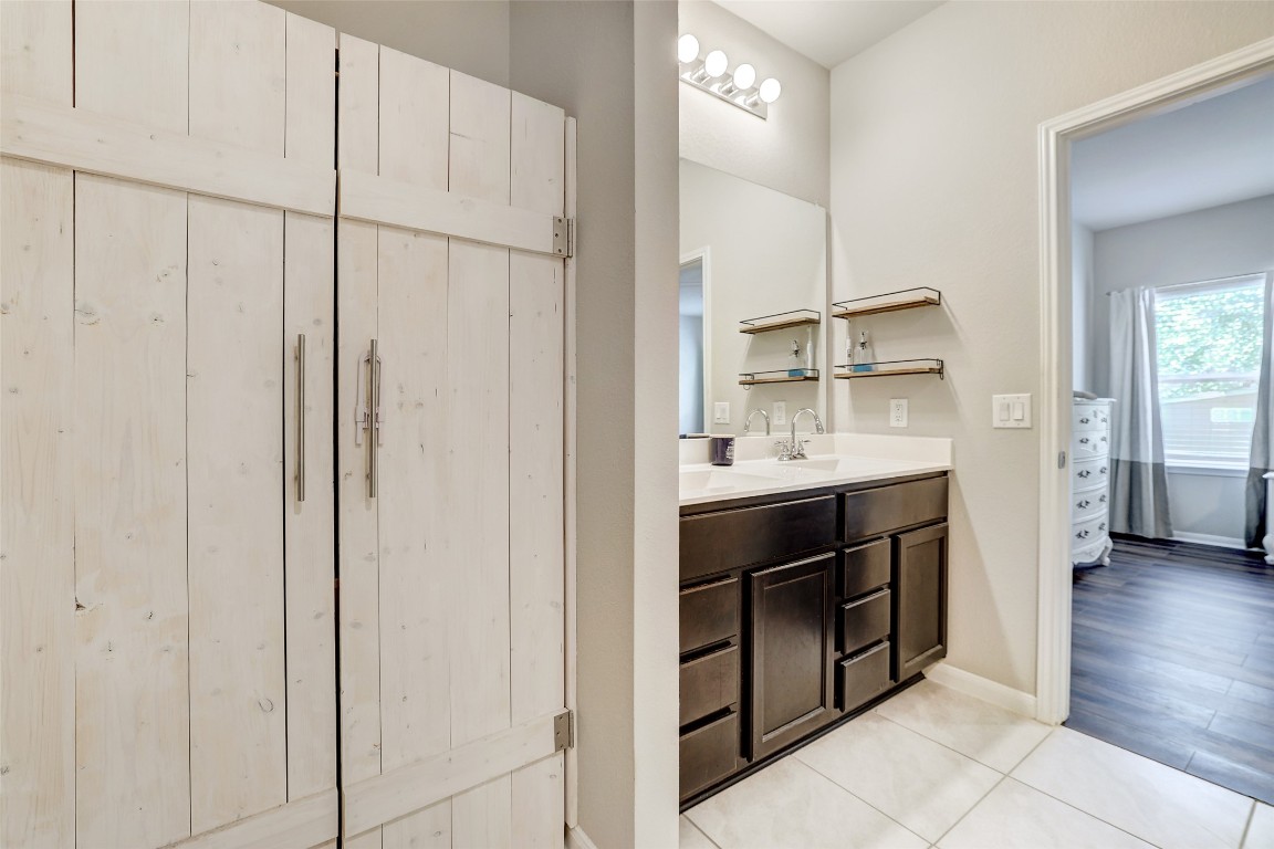 6709 Branrust Drive Austin, TX 78744 - Photo 16 of 35 a bathroom with a double vanity sink a vanity and a mirror