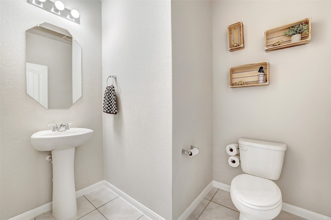 6709 Branrust Drive Austin, TX 78744 - Photo 18 of 35 a bathroom with a toilet sink and mirror