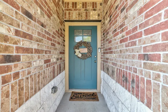 a view of a hallway with wooden door
