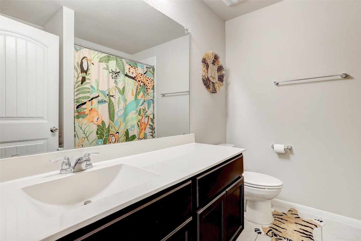 6709 Branrust Drive Austin, TX 78744 - Photo 22 of 35 a bathroom with a sink a toilet and a mirror