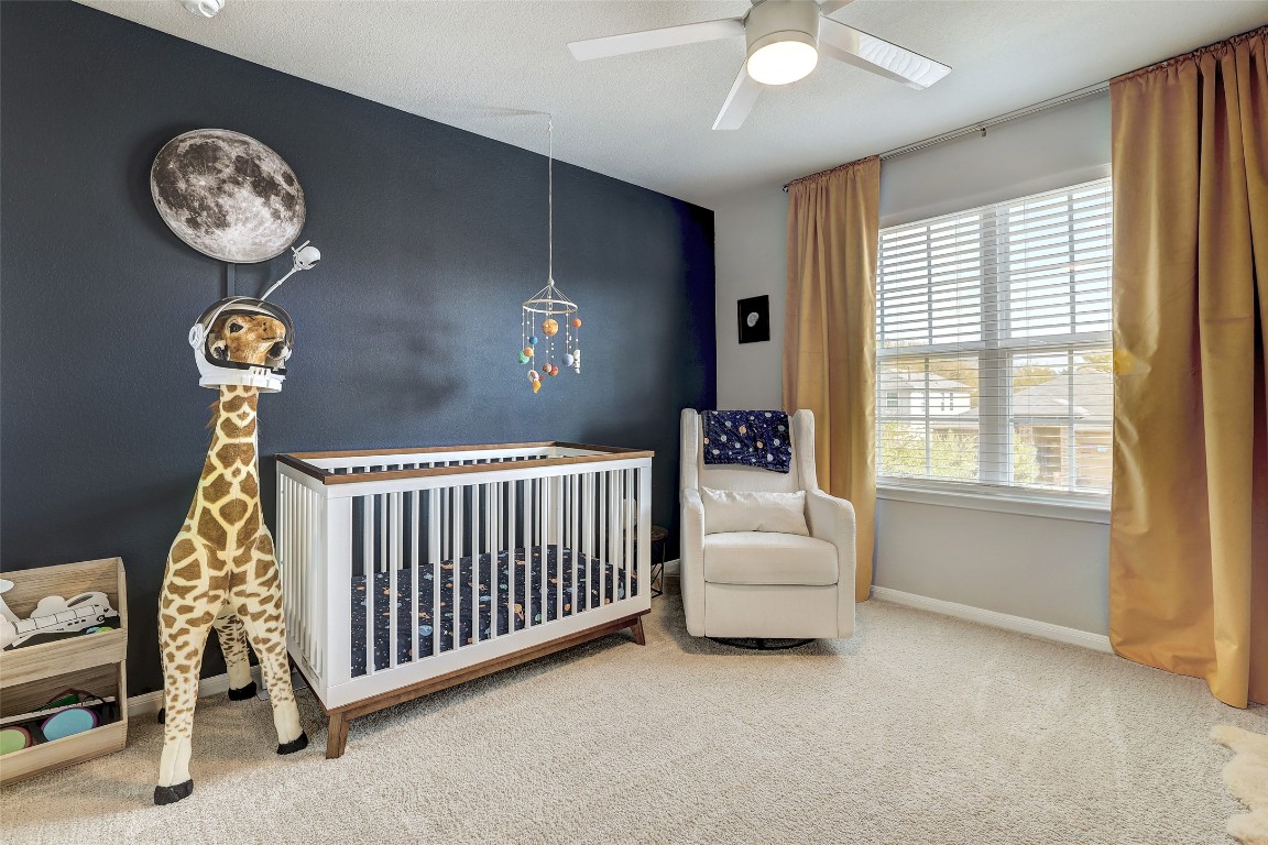 6709 Branrust Drive Austin, TX 78744 - Photo 23 of 35 a bedroom with a bed and a window