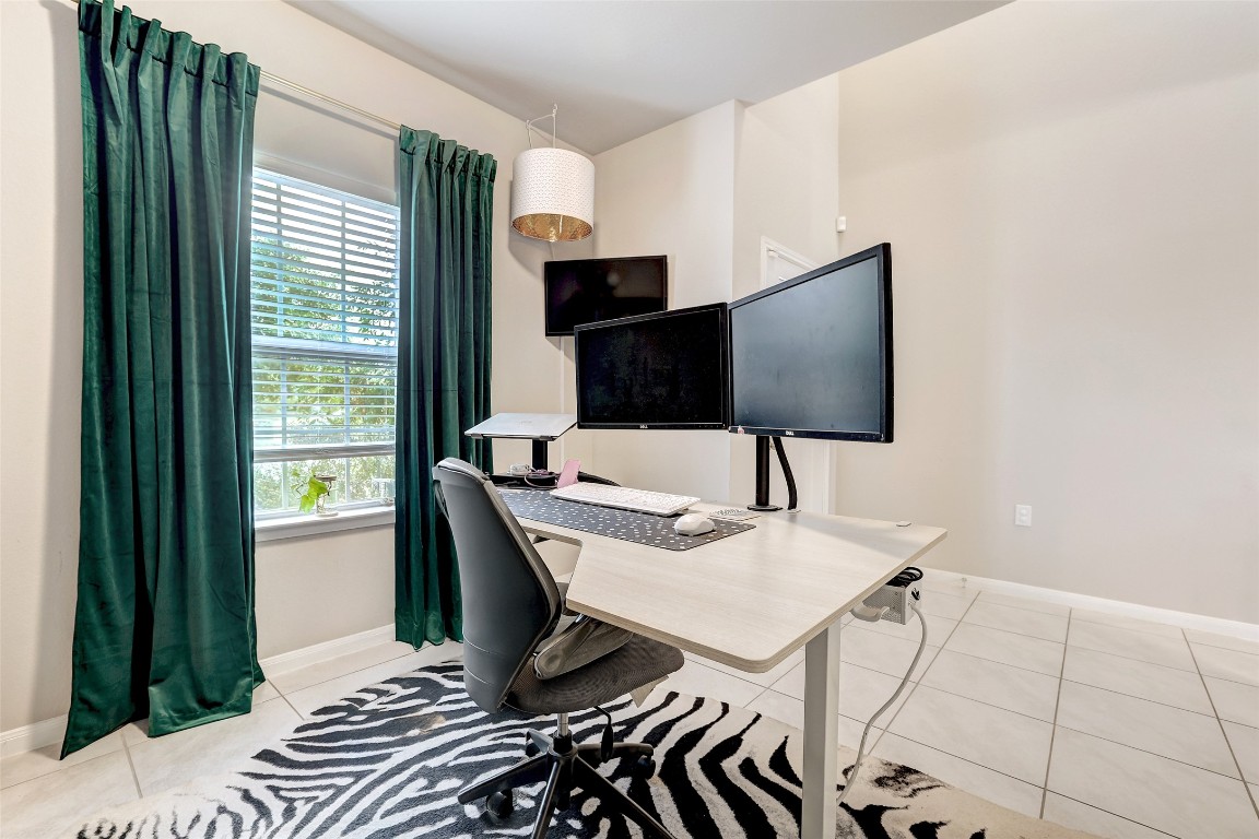 6709 Branrust Drive Austin, TX 78744 - Photo 4 of 35 a workspace with furniture and a flat screen tv