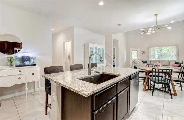 a view of a dining room with furniture and a chandelier