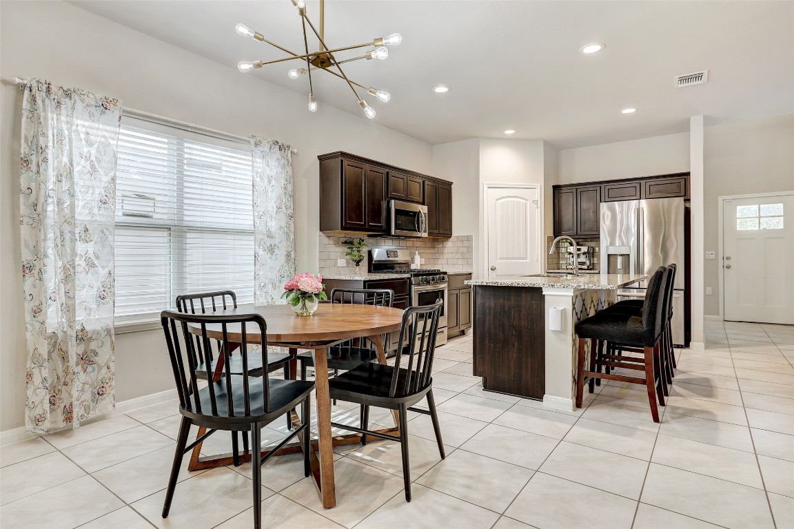 6709 Branrust Drive Austin, TX 78744 - Photo 10 of 35 a dining room with furniture a window and kitchen view