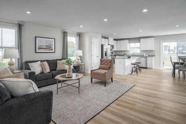 a living room with furniture wooden floor and a table