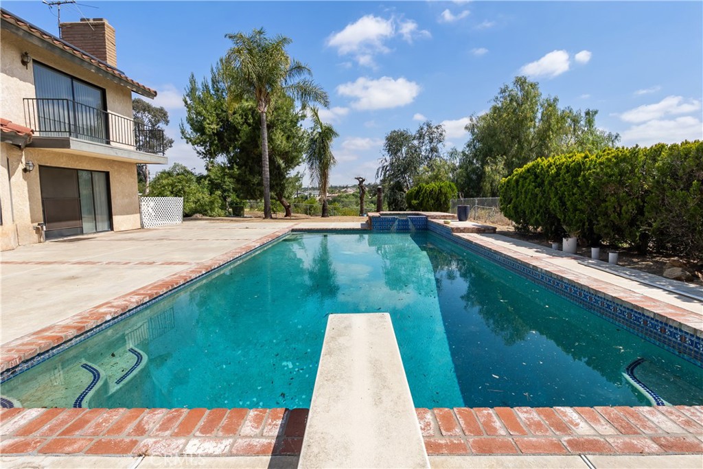 17656 Mockingbird Hill Circle Riverside, CA 92504 - Photo 30 of 49 a view of a swimming pool with a yard