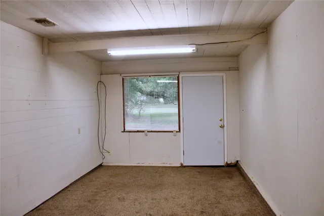 a view of a house with backyard and a tree