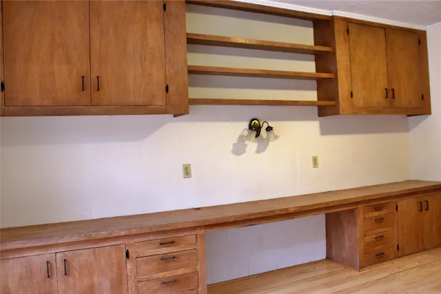 a view of a backyard with wooden fence