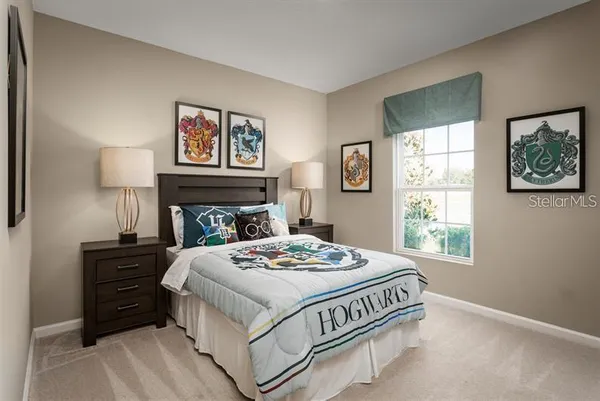 a bedroom with a bed and painting on the wall