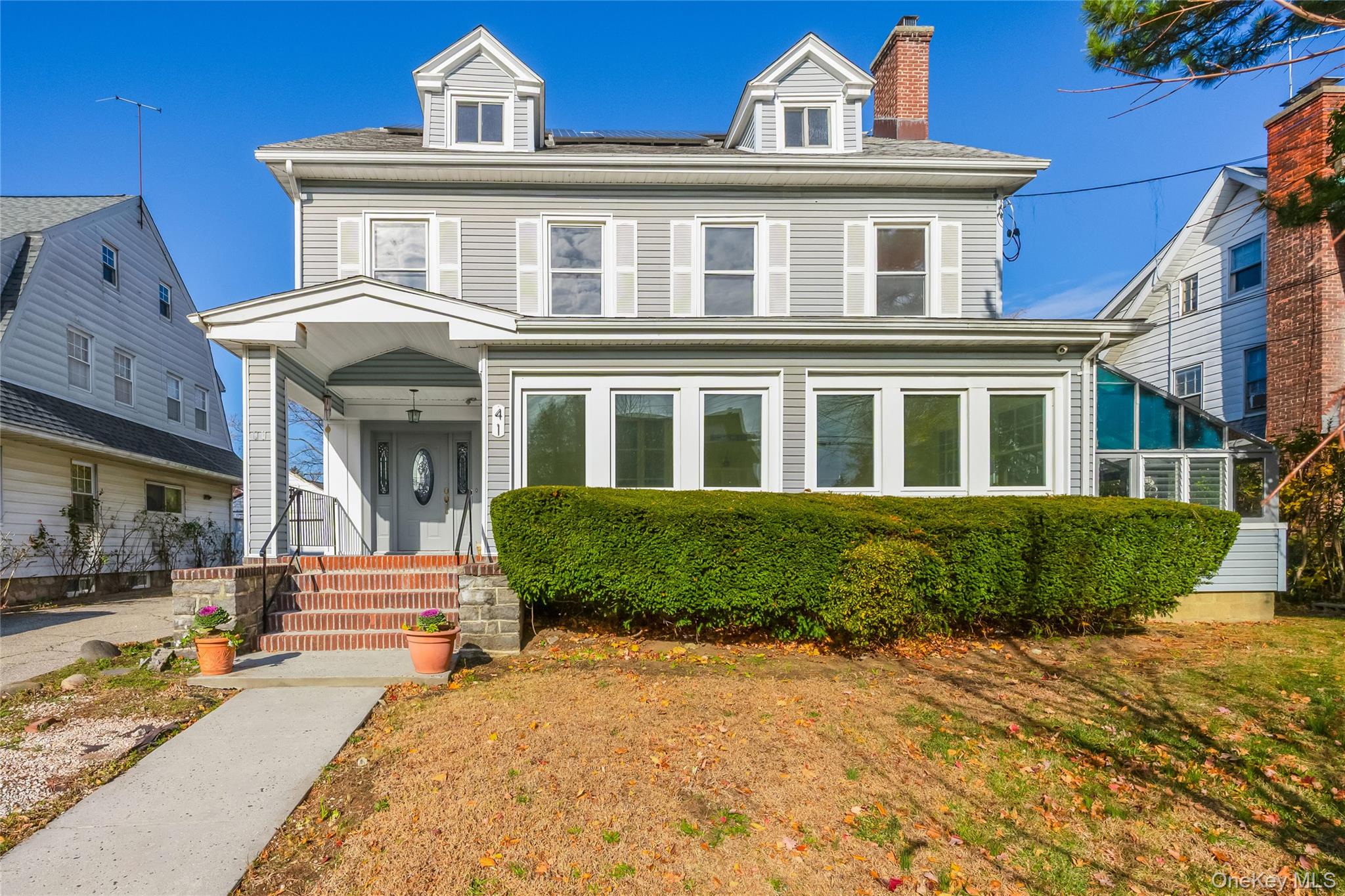 a front view of a house with a garden