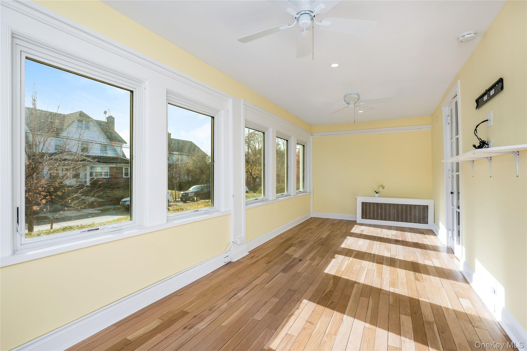 41 French Ridge New Rochelle, NY 10801 - Photo 11 of 50 a view of an empty room with wooden floor and a window