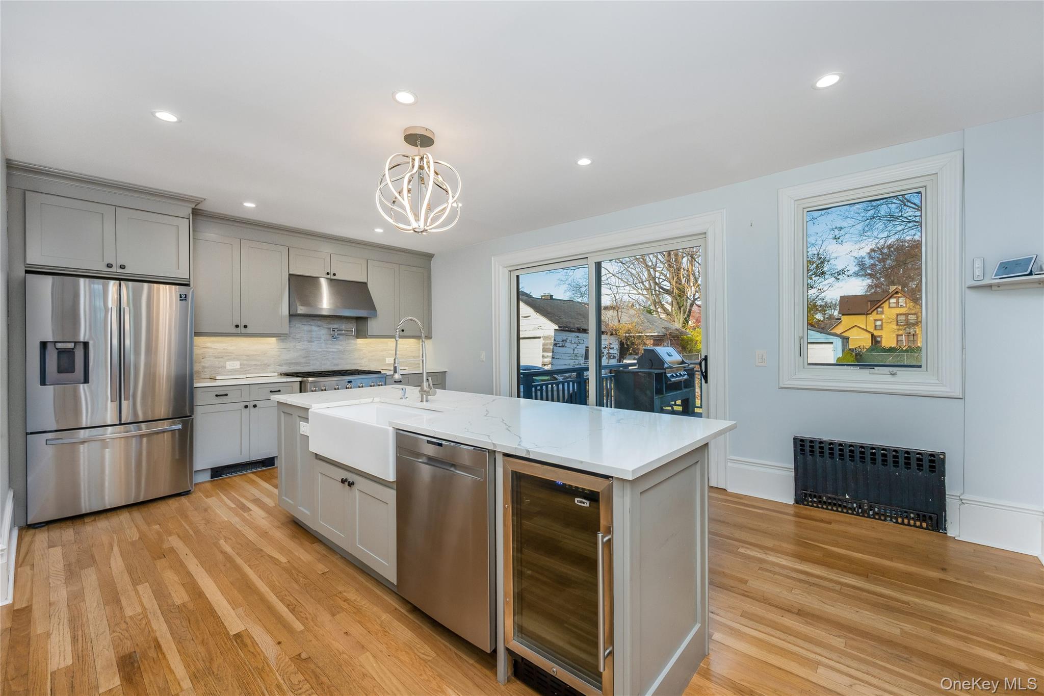 41 French Ridge New Rochelle, NY 10801 - Photo 12 of 50 a kitchen with stainless steel appliances granite countertop a refrigerator a stove microwave and a dining table with wooden floor