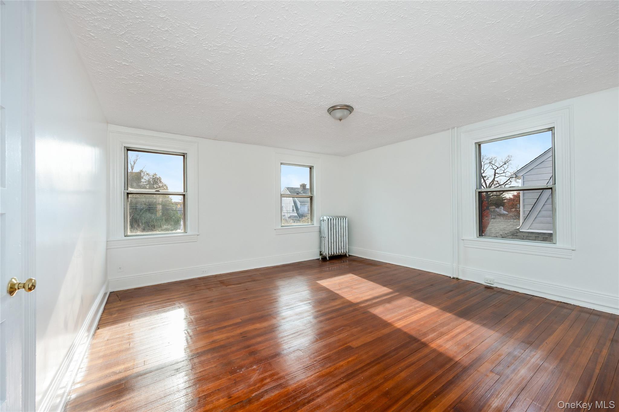 41 French Ridge New Rochelle, NY 10801 - Photo 17 of 50 a view of an empty room with wooden floor and a window