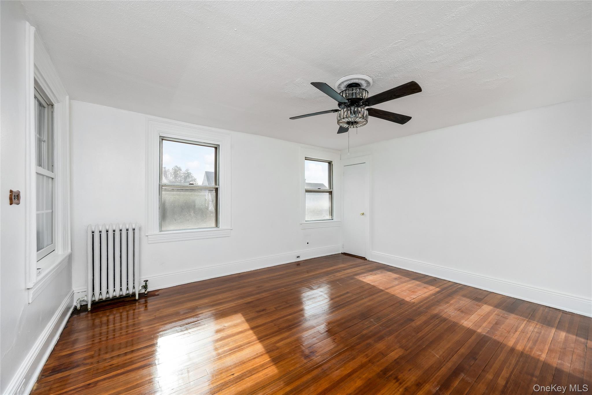 41 French Ridge New Rochelle, NY 10801 - Photo 20 of 50 an empty room with wooden floor and windows