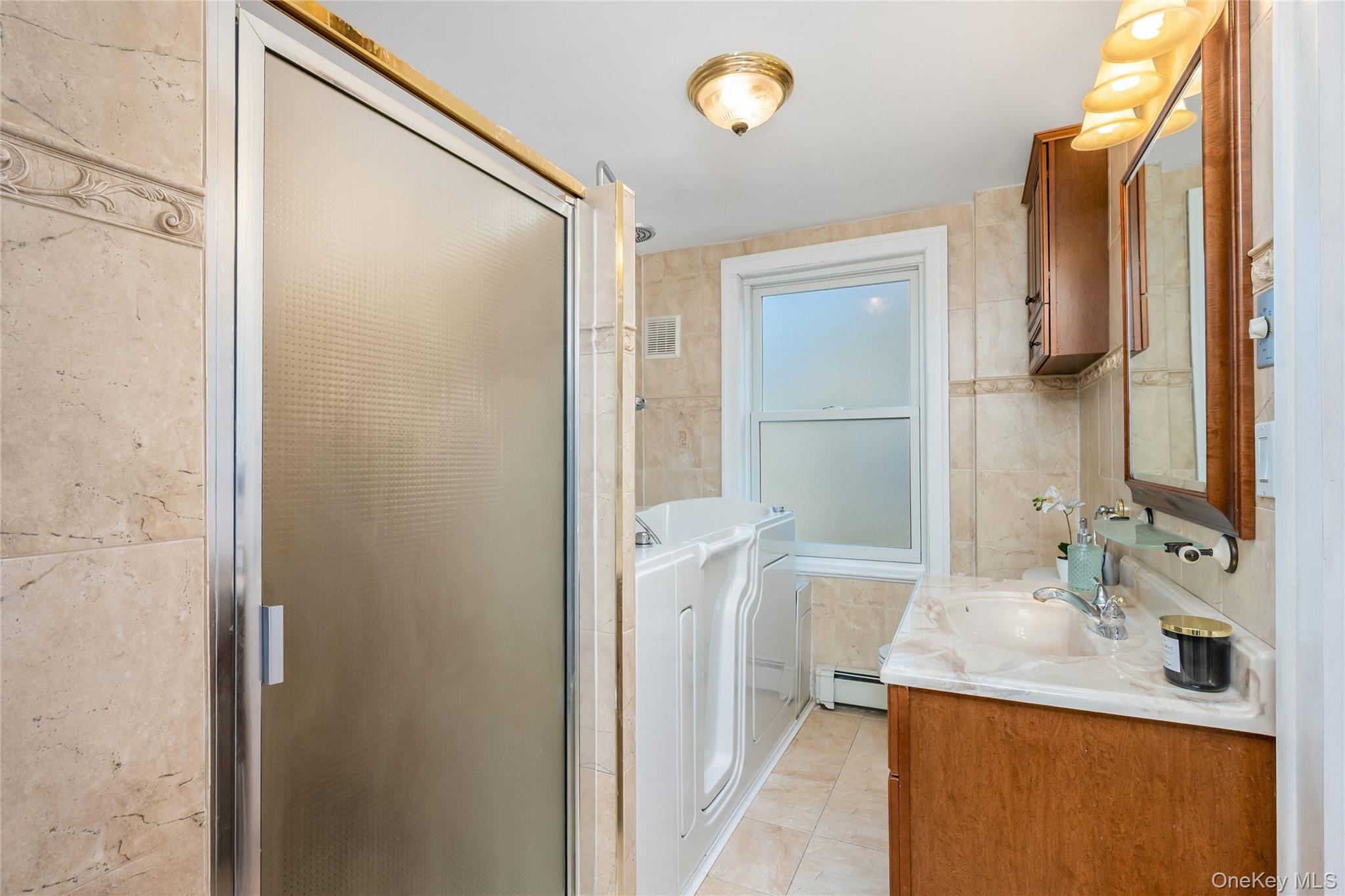41 French Ridge New Rochelle, NY 10801 - Photo 21 of 50 a bathroom with a granite countertop sink and a mirror