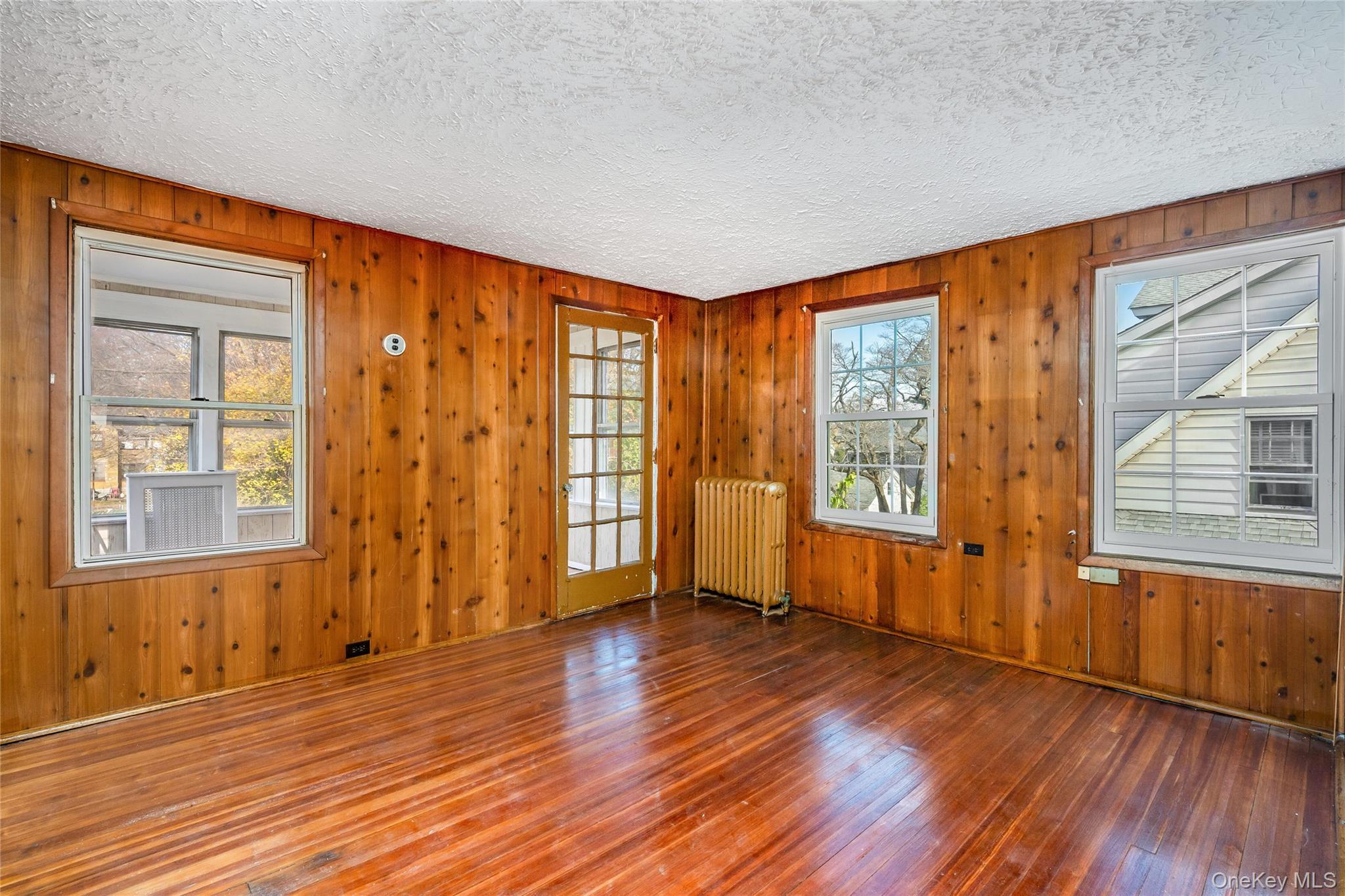 41 French Ridge New Rochelle, NY 10801 - Photo 23 of 50 a view of an empty room with wooden floor and a window
