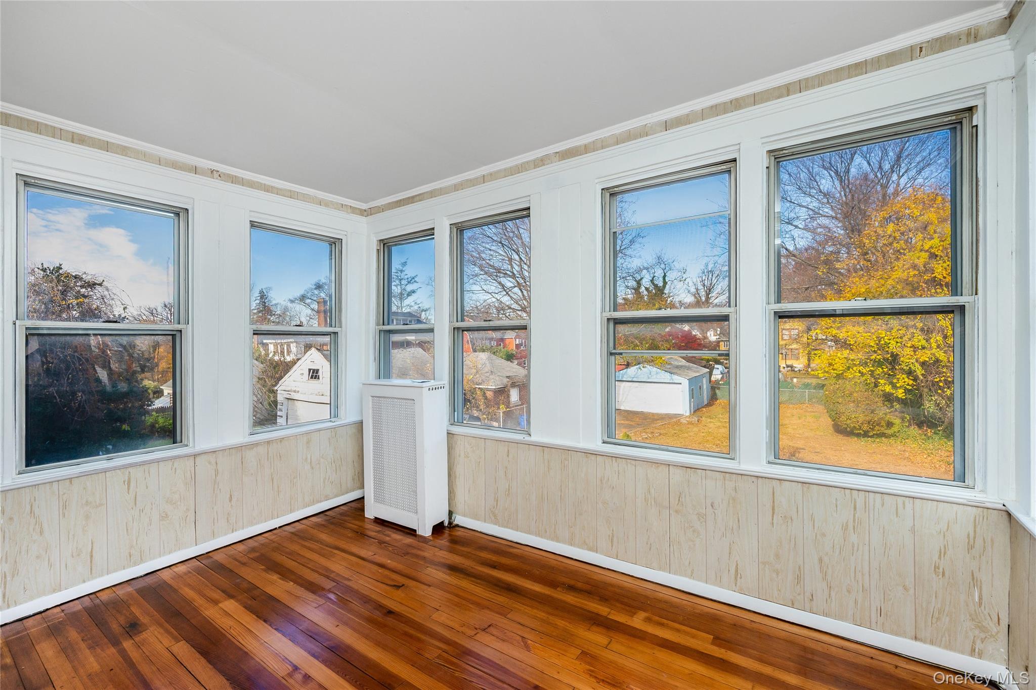 41 French Ridge New Rochelle, NY 10801 - Photo 24 of 50 a view of an empty room with a window and wooden floor