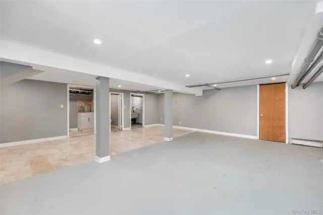 a view of an empty room with closet and a window