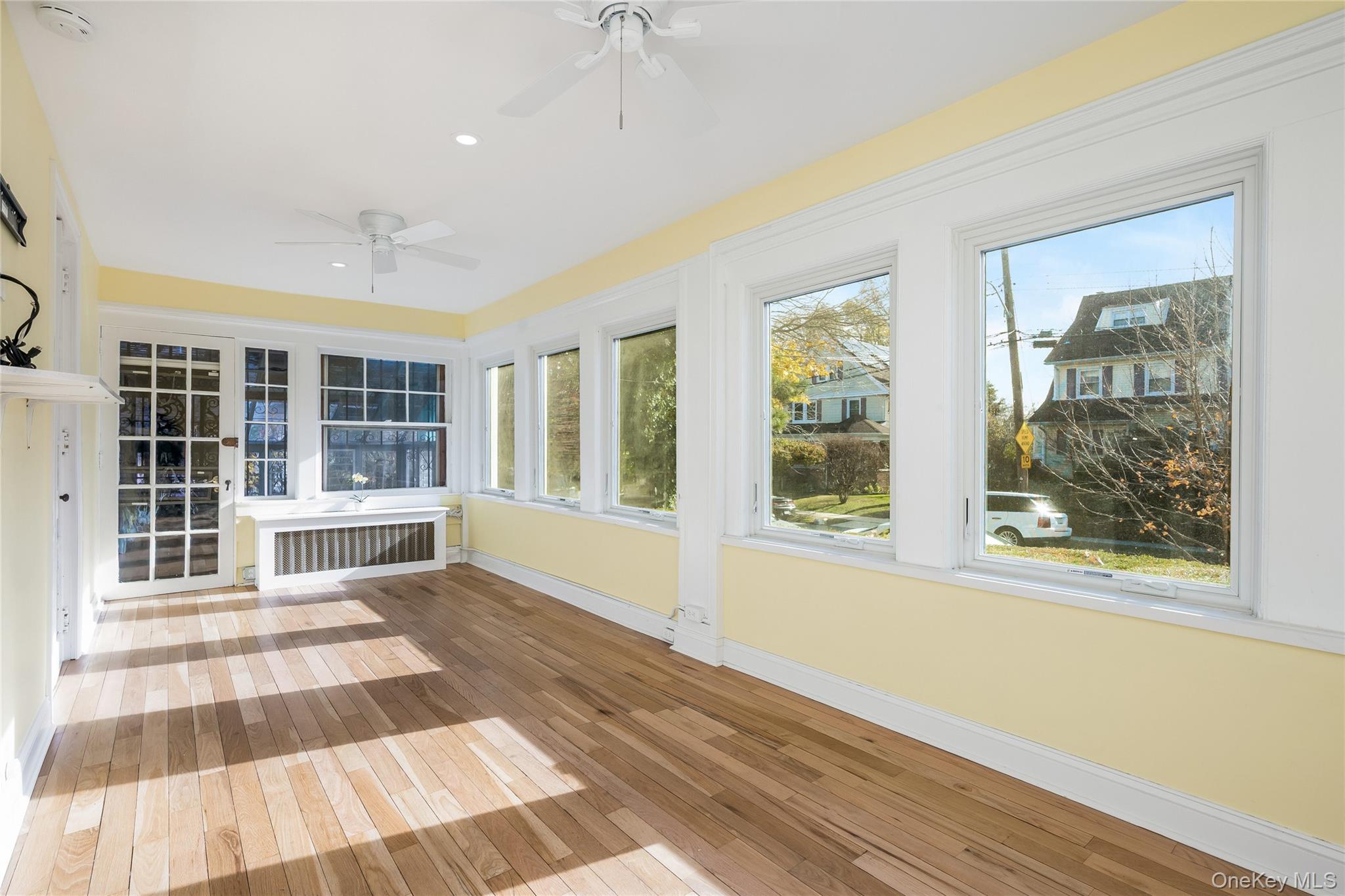 41 French Ridge New Rochelle, NY 10801 - Photo 10 of 50 a view of an empty room with wooden floor and a window