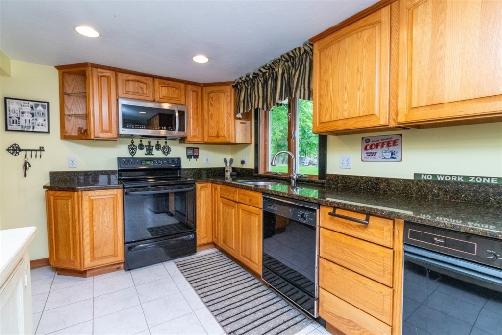 118 Bruce Road Walpole, MA 02081 - Photo 4 of 30 a kitchen with stainless steel appliances granite countertop a stove a sink and a microwave