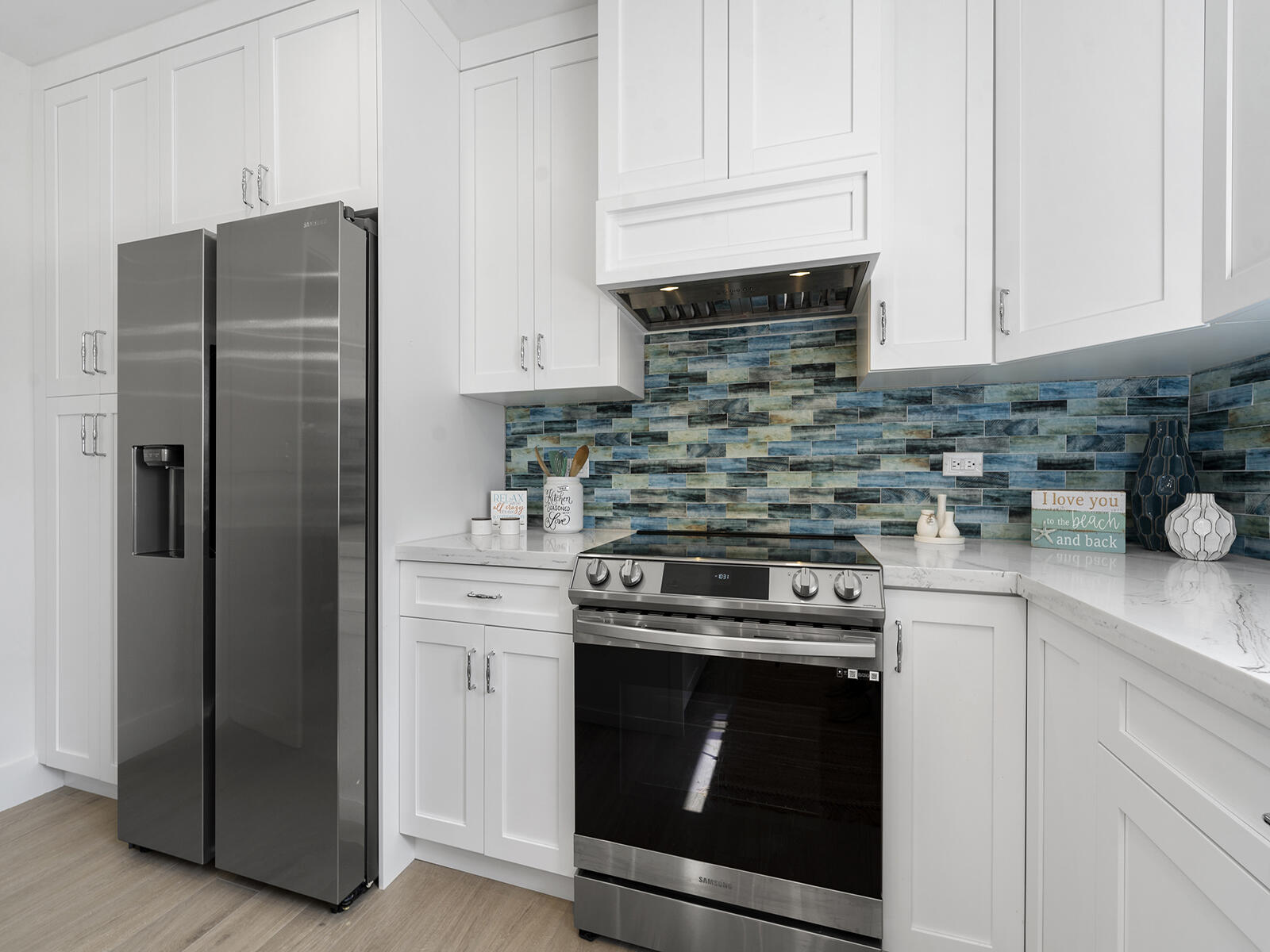 22 Atlantic Boulevard, Unit B Key Largo, FL 33037 - Photo 11 of 50 a kitchen with stainless steel appliances white cabinets and a refrigerator
