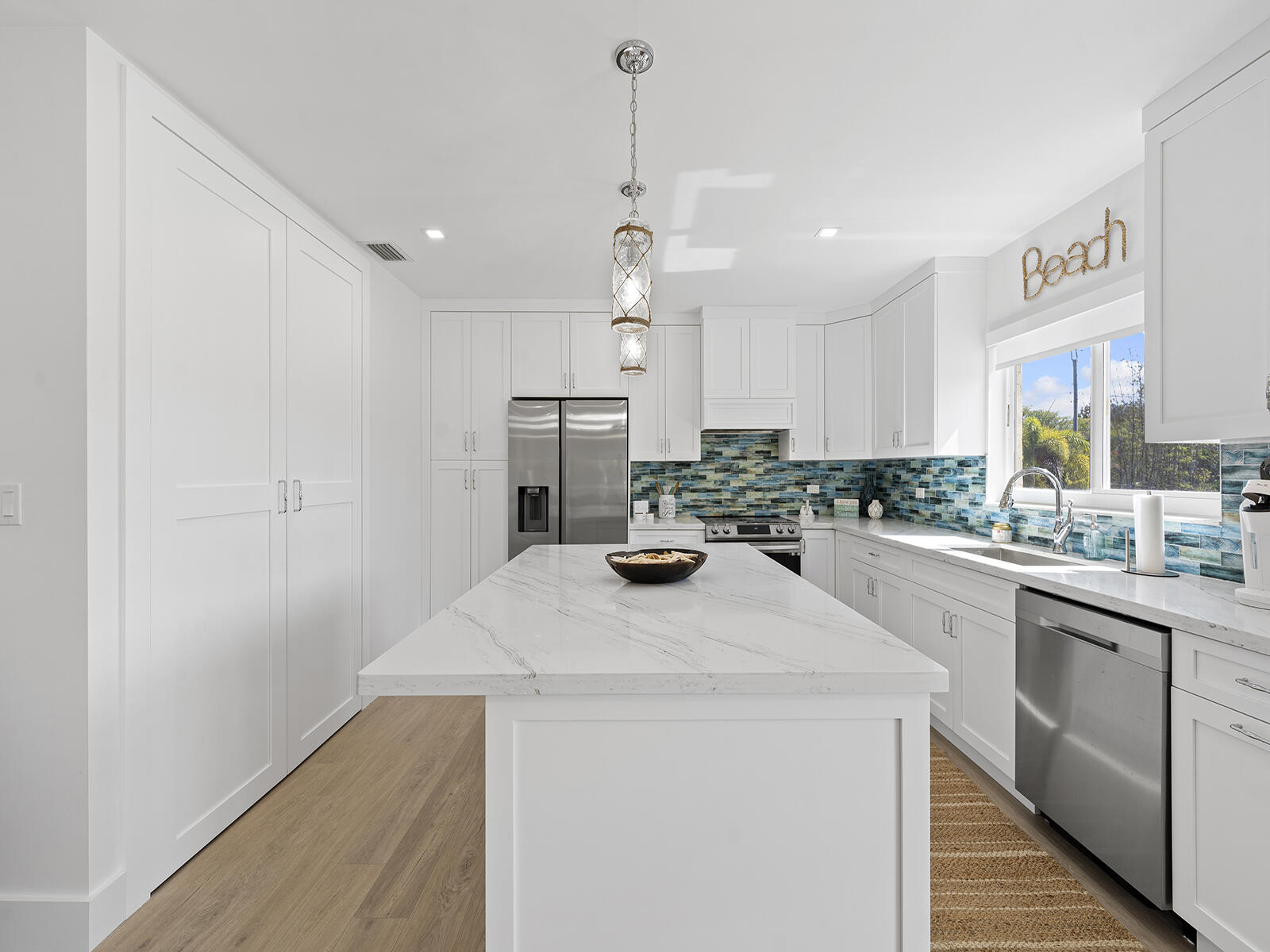 22 Atlantic Boulevard, Unit B Key Largo, FL 33037 - Photo 14 of 50 a kitchen with a sink a stove and cabinets