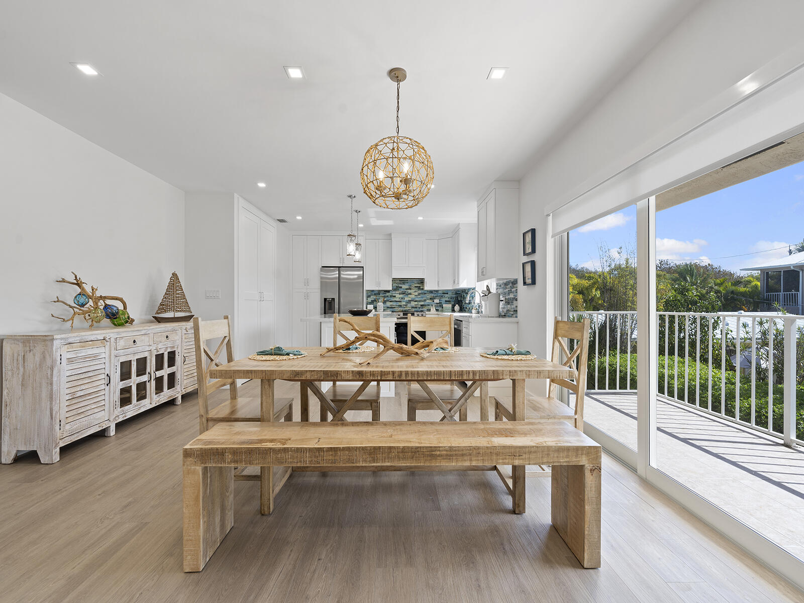 22 Atlantic Boulevard, Unit B Key Largo, FL 33037 - Photo 15 of 50 a view of a living room and dining room with wooden floor a chandelier