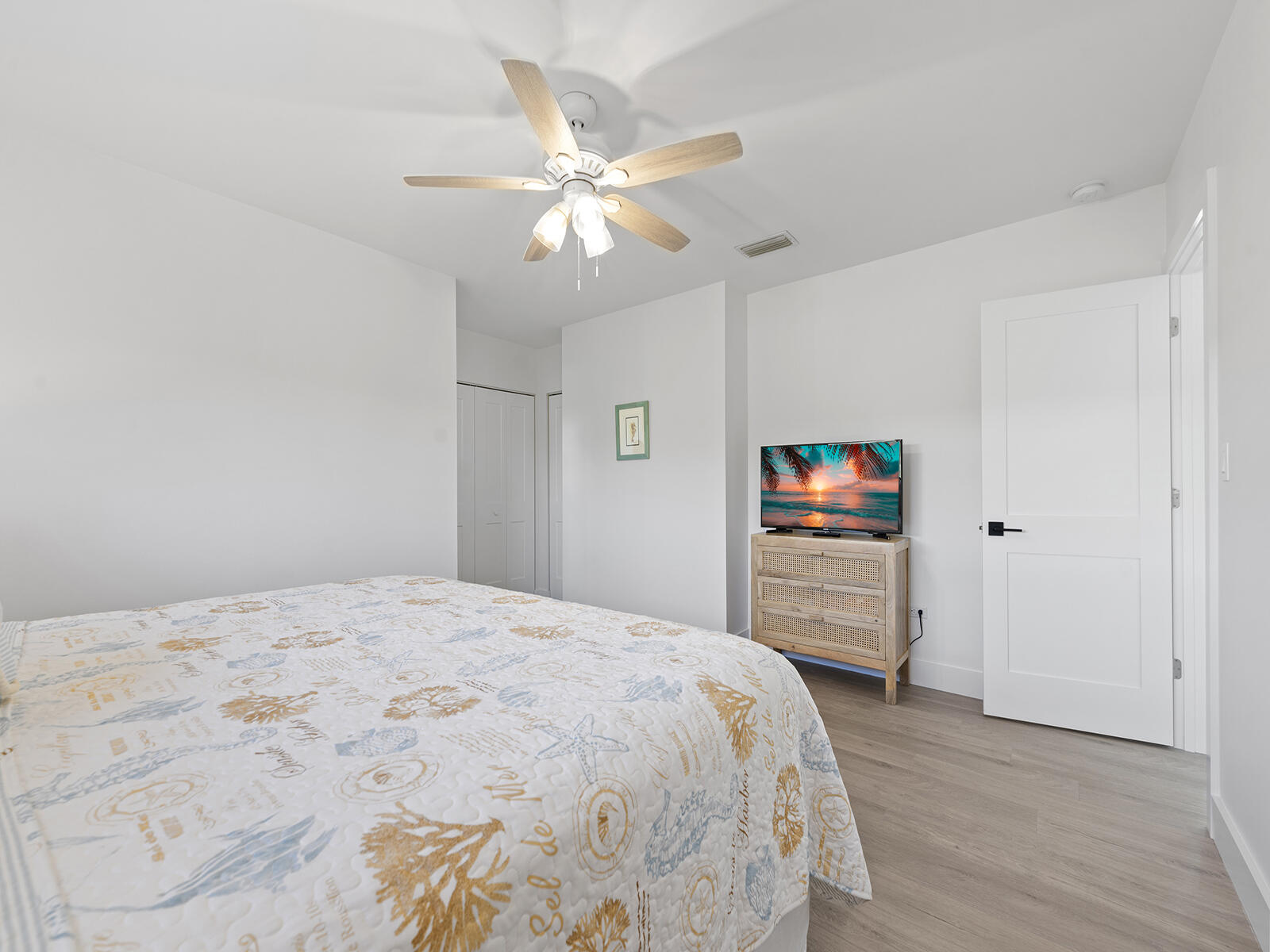 22 Atlantic Boulevard, Unit B Key Largo, FL 33037 - Photo 21 of 50 a bedroom with a bed and a chandelier