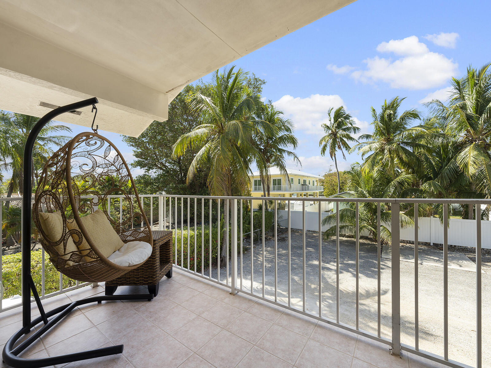 22 Atlantic Boulevard, Unit B Key Largo, FL 33037 - Photo 31 of 50 a view of a swimming pool with a tub and wooden fence