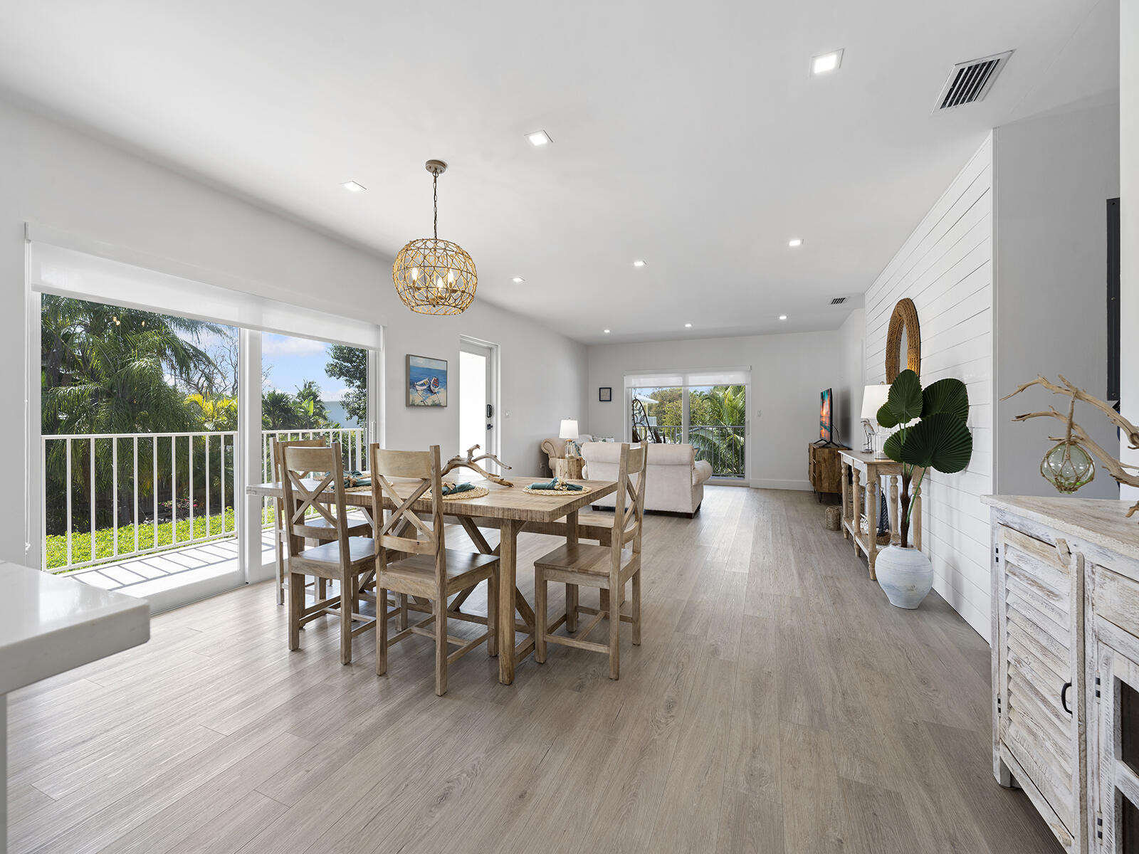 22 Atlantic Boulevard, Unit B Key Largo, FL 33037 - Photo 4 of 50 a view of a dining room and livingroom with furniture wooden floor a chandelier