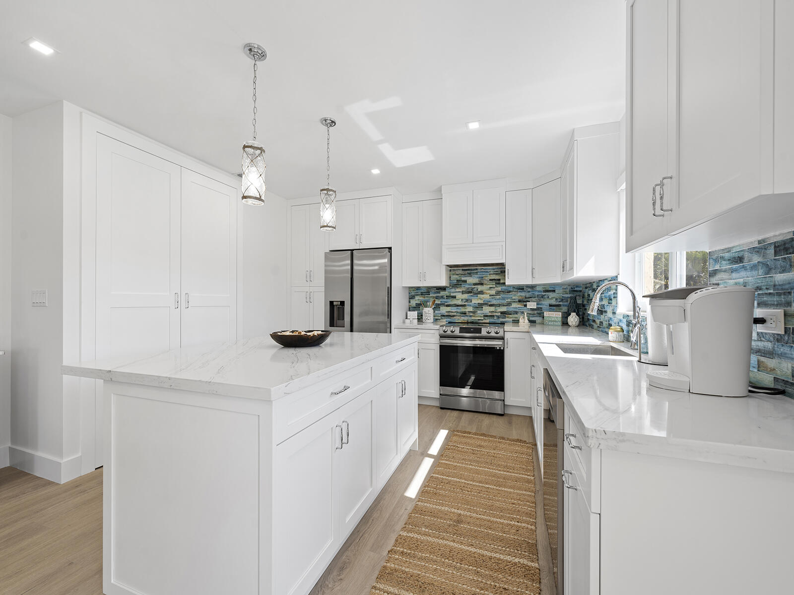 22 Atlantic Boulevard, Unit B Key Largo, FL 33037 - Photo 7 of 50 a kitchen with kitchen island a counter top space a sink stainless steel appliances and cabinets