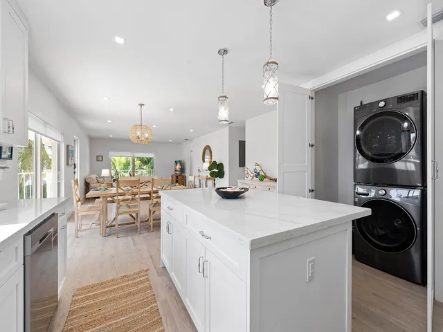 a kitchen with a sink a stove and chairs