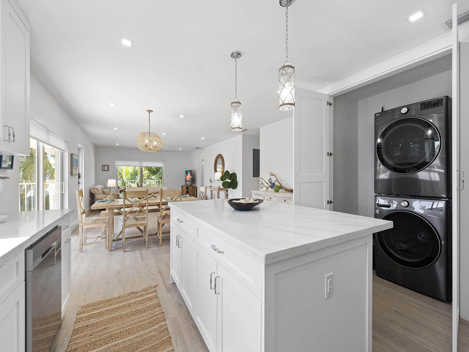 22 Atlantic Boulevard, Unit B Key Largo, FL 33037 - Photo 9 of 50 a kitchen with a sink a stove and chairs