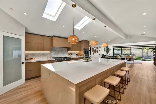 a large kitchen with a table and chairs