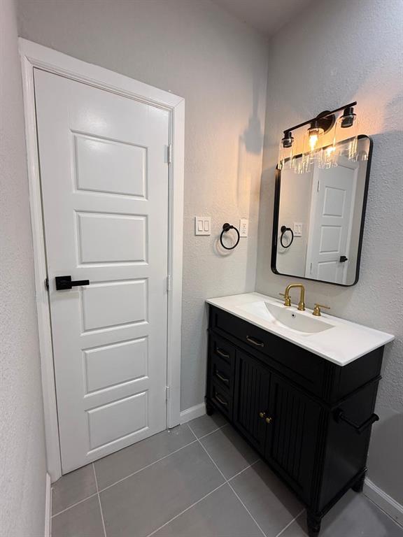 758 Bethpage Avenue Dallas, TX 75217 - Photo 19 of 20 a bathroom with a sink vanity and mirror