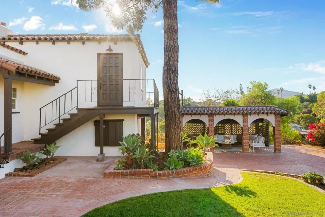 a outdoor living space with furniture and a black umbrella