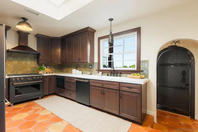 a kitchen with stainless steel appliances a stove and a refrigerator