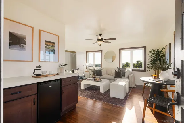 a living room with furniture and a wooden floor