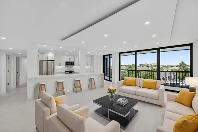 a view of kitchen with kitchen island white cabinets and stainless steel appliances