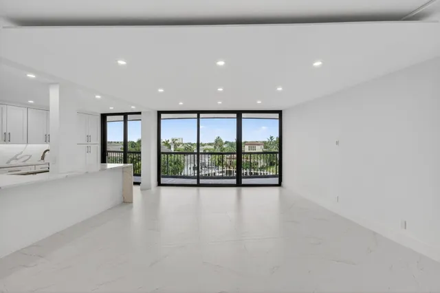 wooden floor in an empty room with a large window