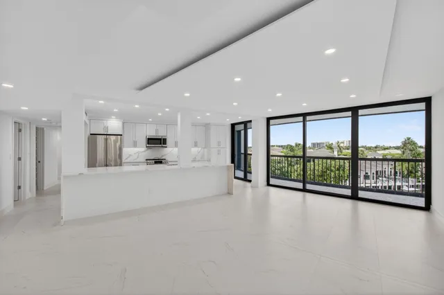 a spacious bedroom with a bed couch and a large window