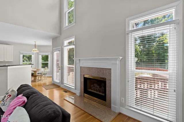 a living room with fireplace furniture and a flat screen tv