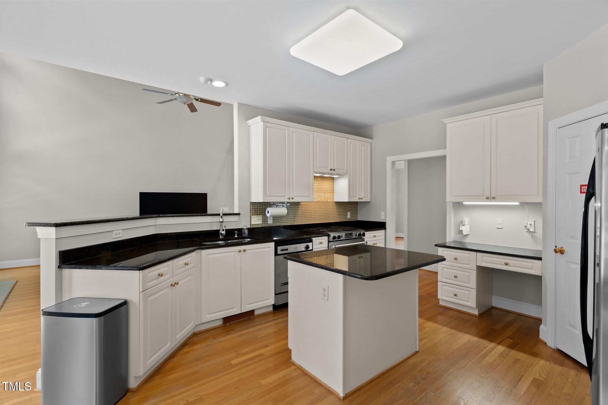 3556 Iris Street Wilmington, NC 28409 - Photo 12 of 52 a kitchen with granite countertop a sink stove and refrigerator