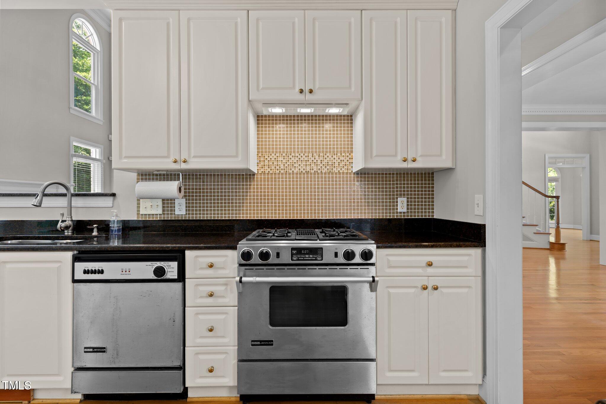 3556 Iris Street Wilmington, NC 28409 - Photo 15 of 52 a kitchen with granite countertop white cabinets and white appliances