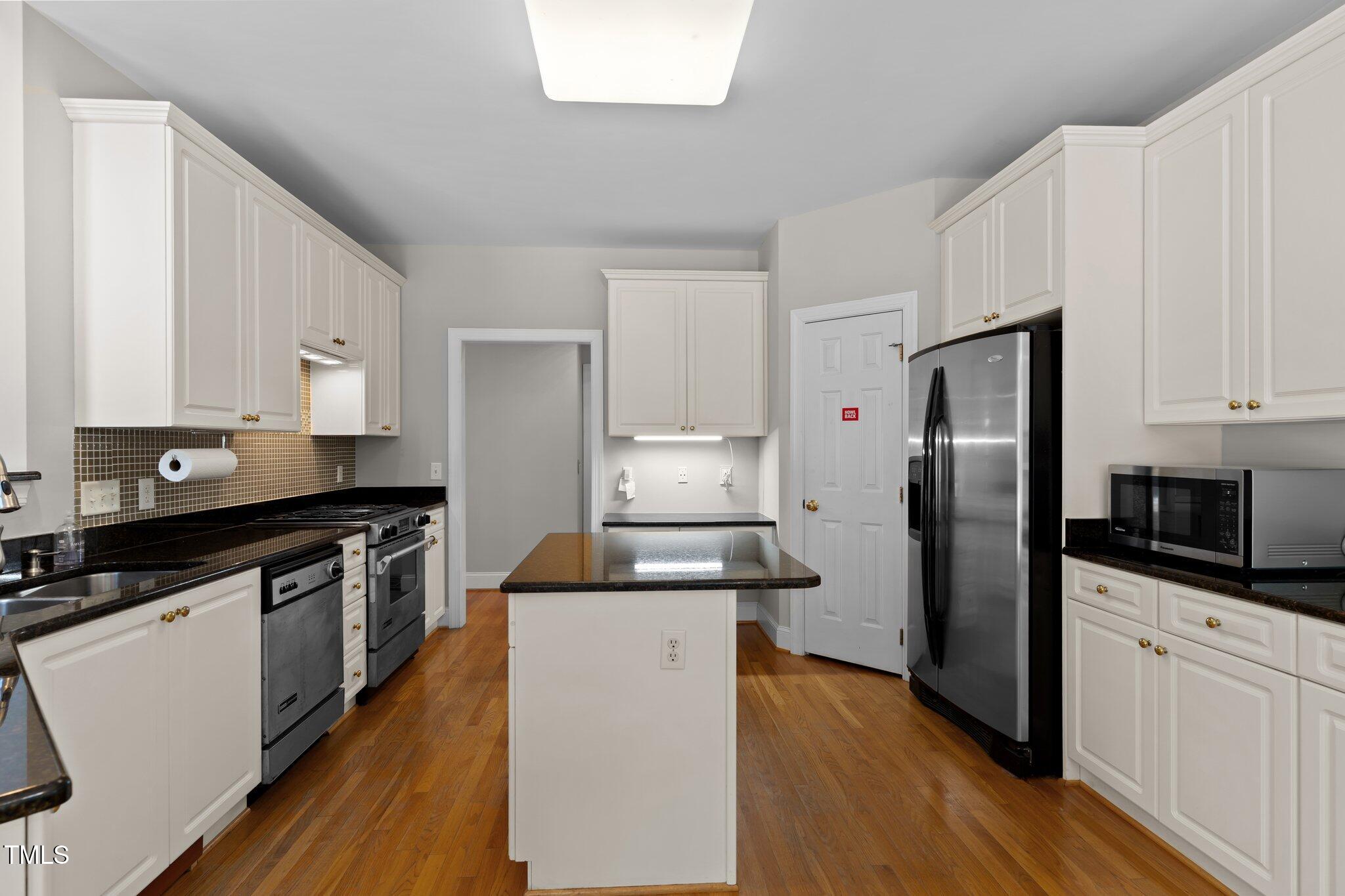 3556 Iris Street Wilmington, NC 28409 - Photo 17 of 52 a kitchen with stainless steel appliances a refrigerator stove and sink